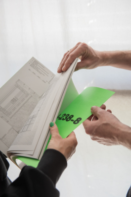  Detail view of a publication and hands at Bank TM's Studio in Berlin Kreuzberg