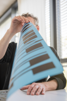  Action photo of Sebastian Bissinger with a poster at Bank TM's Studio in Berlin Kreuzberg